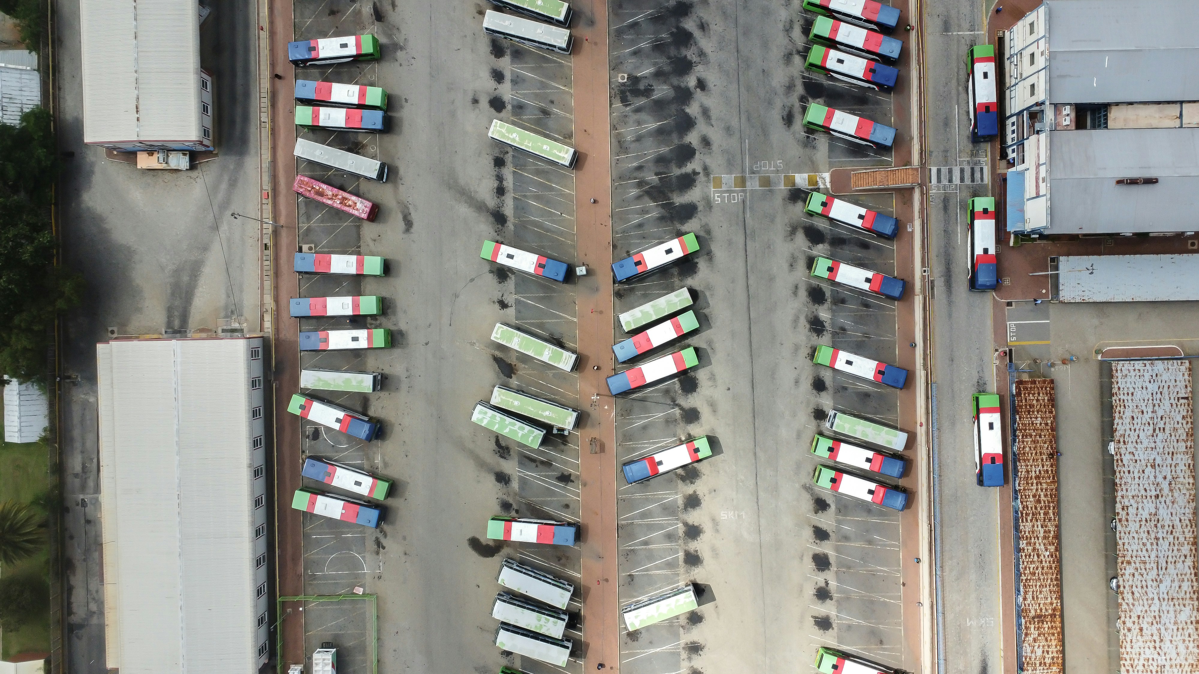 Aerial view of a bus depot with parked buses.